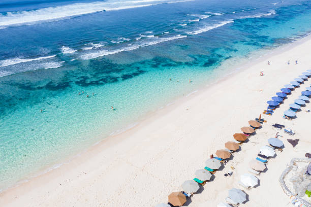 istock Beach umbrellas and blue ocean. Beach scene from above 1214907403