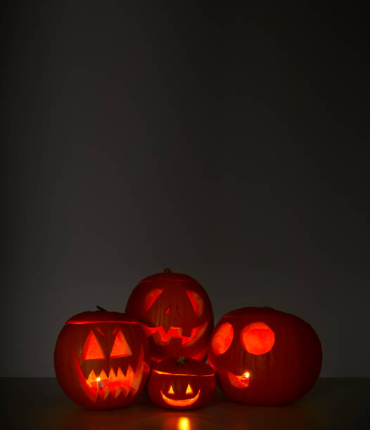 istock Halloween Still Life Composed Of Carved Pumpkin Jack O'Lanterns Illuminated With Candles 1214907652