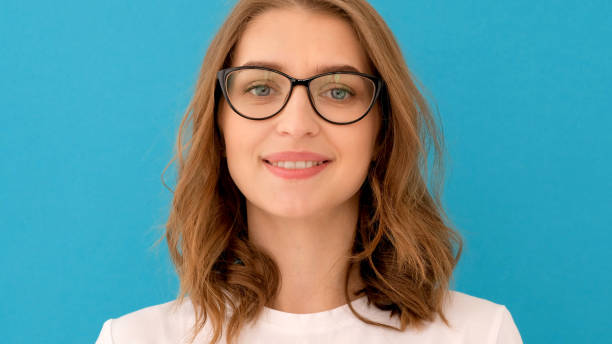 istock Young woman putting on glasses 1214907865