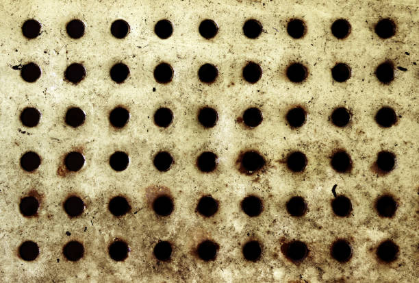 istock A holey metallic old and dirty surface. Grunge yellow gothic gloomy background. 1214909757