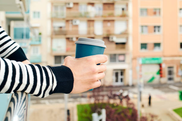 istock young man having a coffee in the balcony 1214912578
