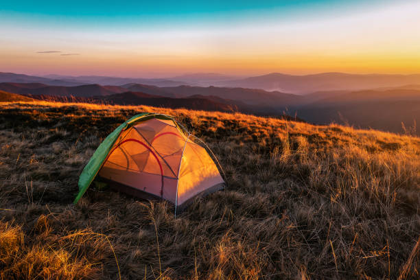istock tent and sunset in the mountains 1214912908