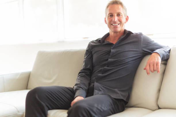 istock Portrait of single 40s man sitting in sofa 1214913502