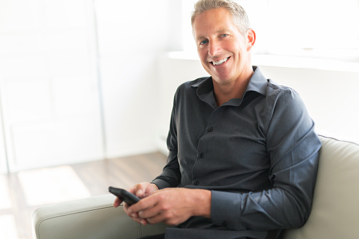 A Portrait of mature man relaxing at home in sofa