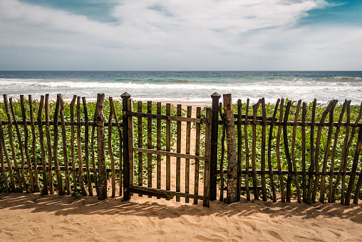 wooden fence with access to the tropical beach