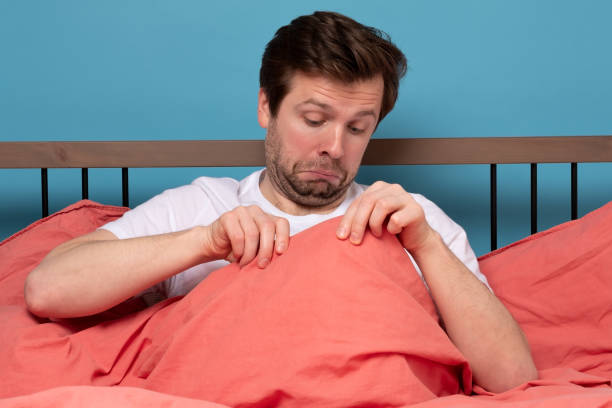 Young caucasian man worrying about his penis and erection failure stock photo