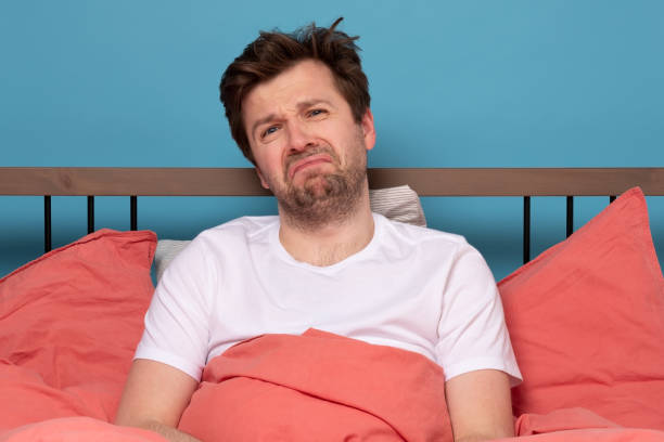 istock man in is exhausted with insomnia or illness being in depression 1214915743