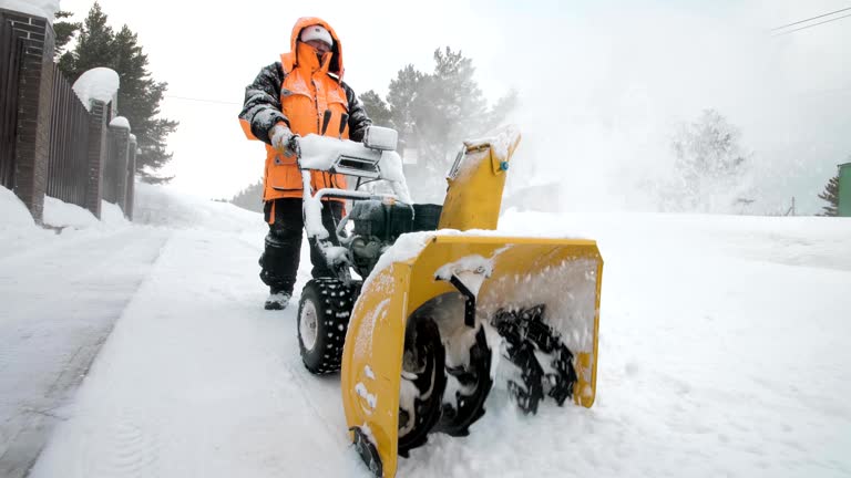 Man cleans snow with a snow thrower. Close up