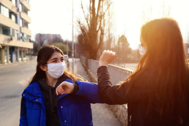 istock Two friends greeting during pandemic 1214916323