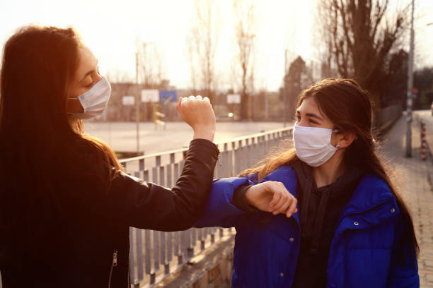 istock Two friends greeting during pandemic 1214916881