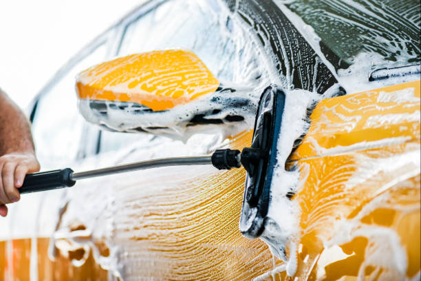 istock Man cleaning car with high pressure water jet. 1214919202