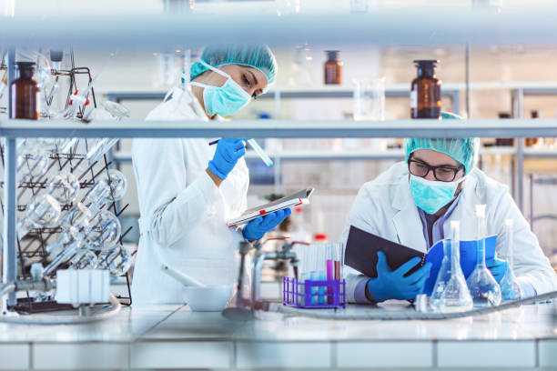 istock Two microbiologists working on medical research in a laboratory. 1214920289