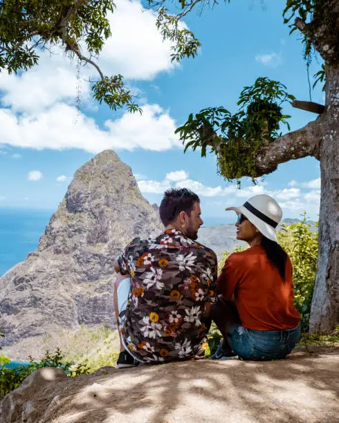 Photo of couple hiking in the mountains Saint Lucia Caribbean, nature trail in the jungle of Saint Lucia with a look at the huge Pitons