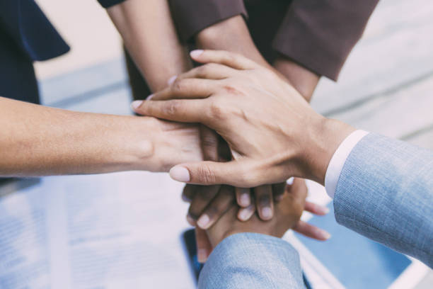 istock Business team putting their hands together 1214922600