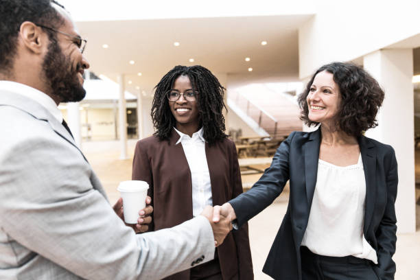 istock Happy positive business partners shaking hands 1214925761