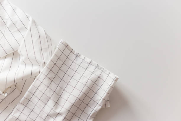 White striped and checkered tablecloth close-up, isolated on white with copy space