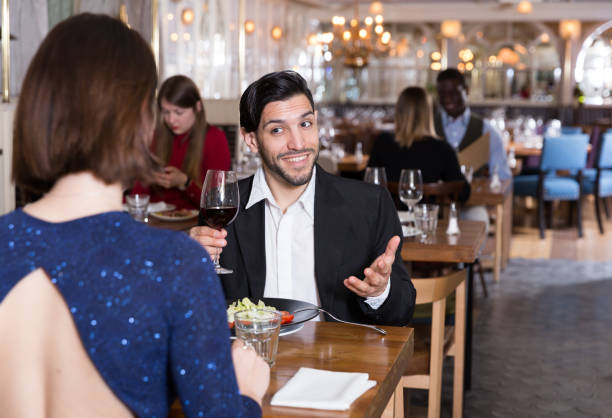 istock Cheerful man with female in restaurant 1214928986