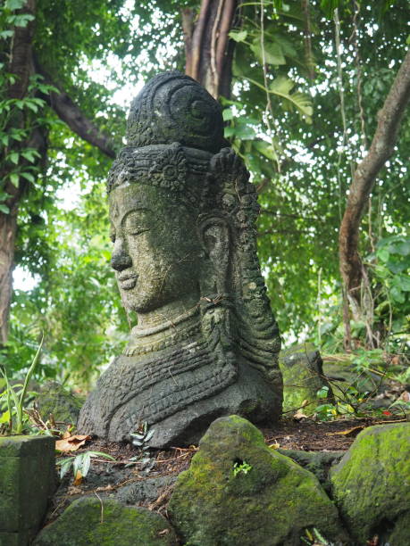 istock Ancient statue of a deity in a tropical forest in Bali 1214929922