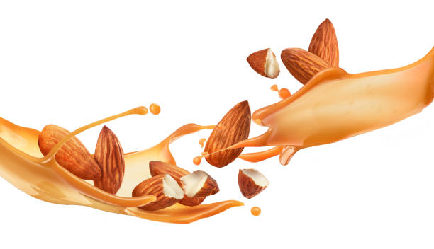 éclaboussure de caramel avec des amandes sur un fond blanc - chocolate almond foods and drinks white chocolate photos et images de collection