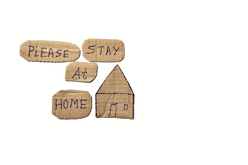 Please Stay At Home Phrase with House Cut Out Isolated on White Background With Copy Space for Texts Wrinting. Healthy Living and Safey Conceptual Photo.