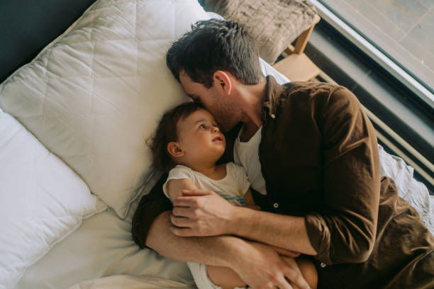 istock Dad and little boy cuddling in the morning 1214930188