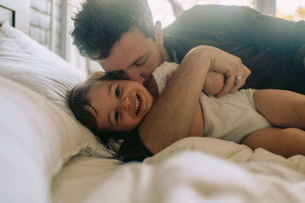 istock Dad and little boy cuddling in the morning 1214930551