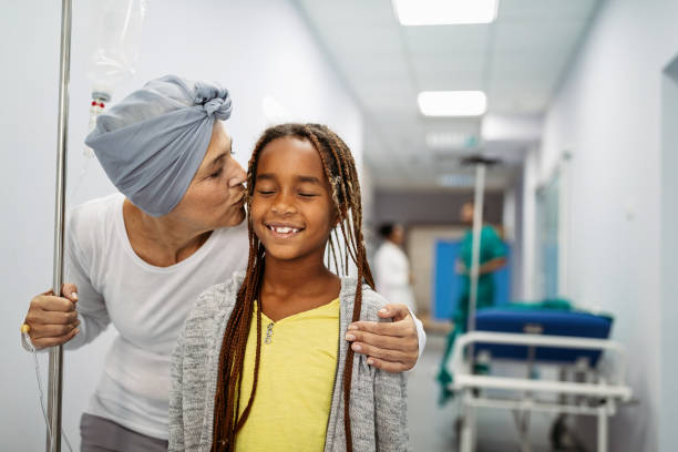Sick woman with cancer hugging her young grandchild in hospital. Family support concept. Sick senior woman with cancer hugging her young grandchild in hospital. Family support concept. cancer illness stock pictures, royalty-free photos & images