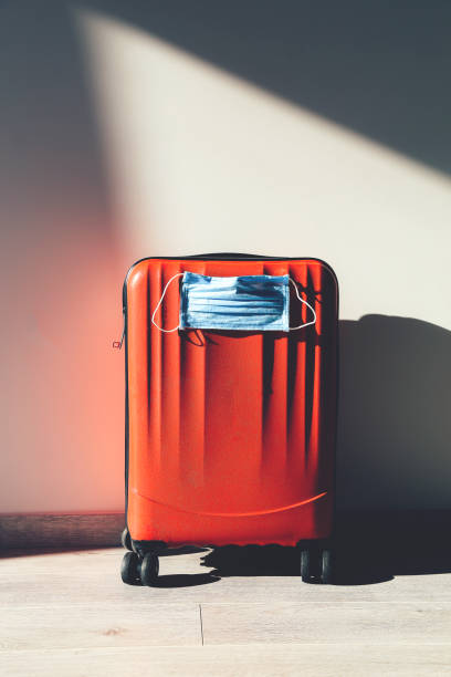istock Personal red luggage with protective mask 1214932745