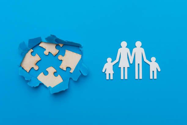 istock World Autism Awareness, concept with puzzle or jigsaw pattern in paper cut hole. Blue background 1214933370