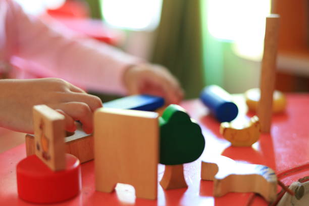 istock kid playing colorful wooden toy blocks, top view 1214933736