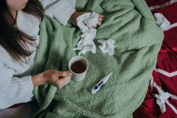 istock Woman sick in bed, covered with blanket 1214933882