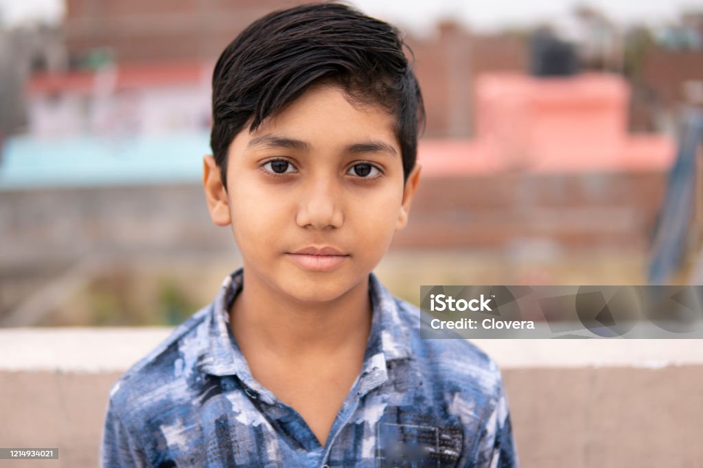 Portrait of little Indian boy looking at camera. Portrait of little Indian boy looking at camera with blank expression. Boys Stock Photo