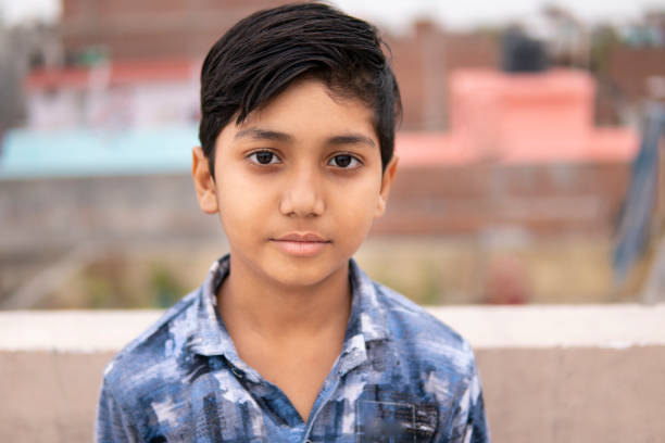 Portrait of little Indian boy looking at camera. Portrait of little Indian boy looking at camera with blank expression. 8 9 years photos stock pictures, royalty-free photos & images