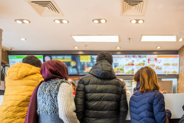a few people wait to order some food - burger king imagens e fotografias de stock