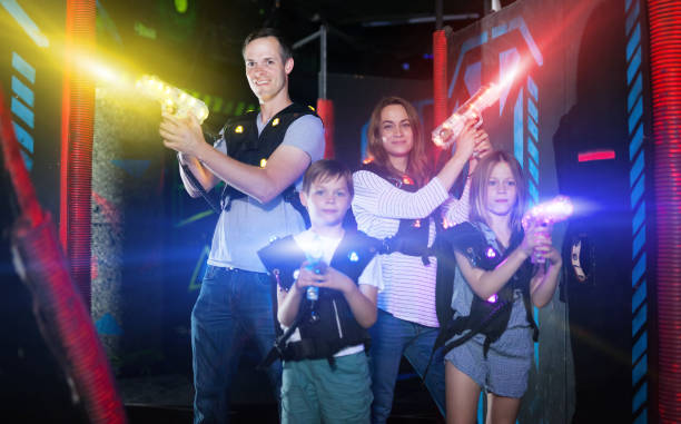 istock Parents and children playing laser tag in beams 1214934935