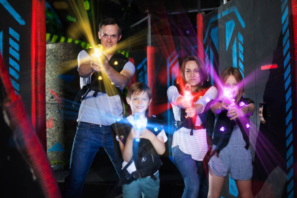 istock Parents and children playing laser tag in beams 1214934939