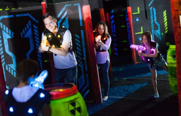 istock Parents and children playing laser tag 1214934975