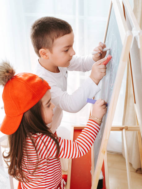 istock Little kids drawing on the blackboard 1214936038