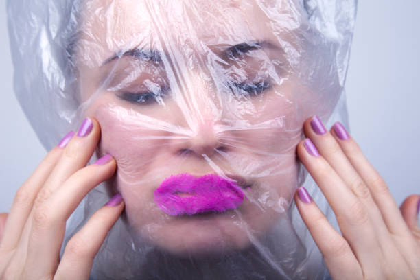 istock Young girl with a plastic bag on her head 1214937706