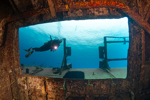 View of the Kittiwake Shipwreck and a female diver in Grand Cayman - Cayman Islands