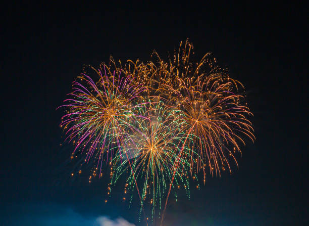 colorful fireworks on the black sky background,firework - explosive material, firework display, cut out, black background - clear sky flash imagens e fotografias de stock