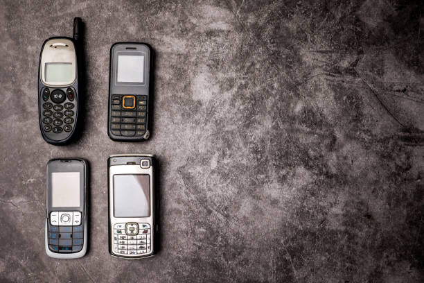 istock Many obsoleted cellphones on a grunge background. 1214942833