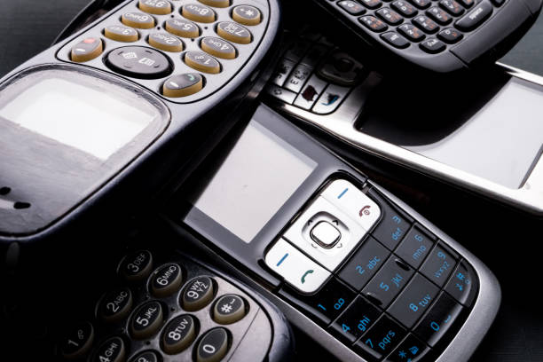 istock Old and obsoleted cellphones on a black background. 1214942880