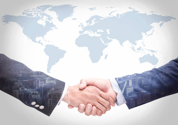 istock Business people shake hands with a map in the background,Agreement, cooperation 1214943053