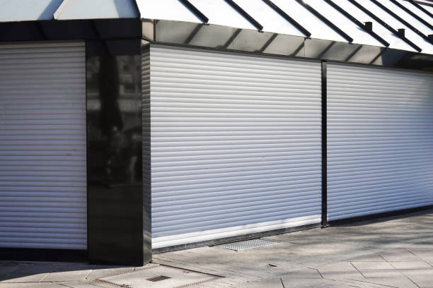 istock closed business shop or store front with roller shutters 1214944150