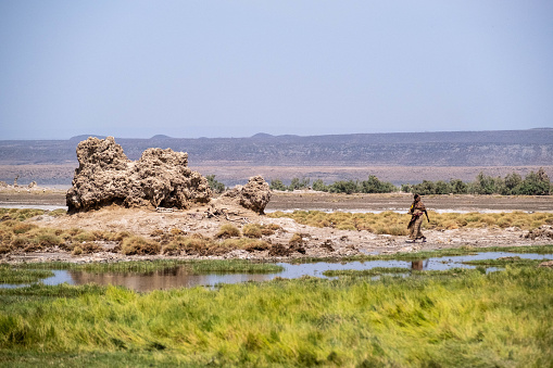 Africa, Djibouti, Lake Abbe. A nomadic women is walking around lake Abbe
