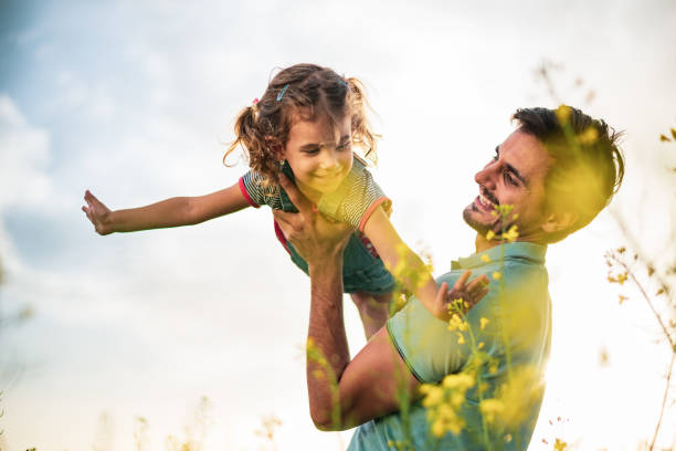 istock Father and daughter enjoying nature 1214946281