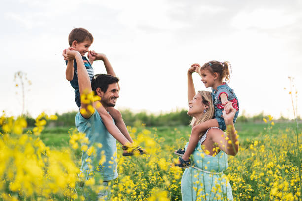 istock Young happy family enjoying nature 1214947352