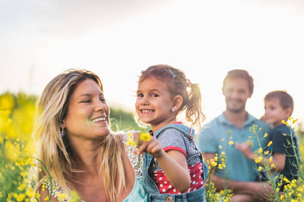 istock Young happy family enjoying nature 1214947677