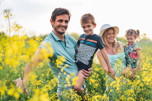 istock Young happy family enjoying nature 1214947790